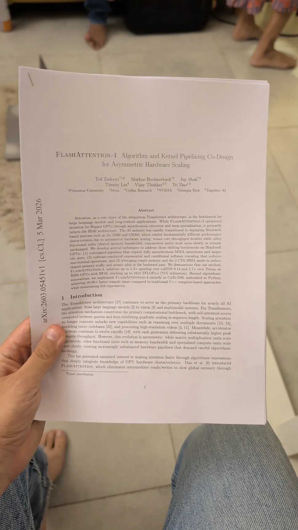 A printed copy of the FlashAttention-4 paper held in someone's hand.